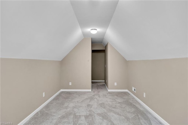 bonus room featuring vaulted ceiling, carpet floors, and baseboards