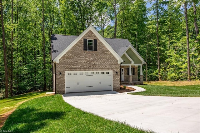 craftsman house with driveway, a front lawn, brick siding, and covered porch