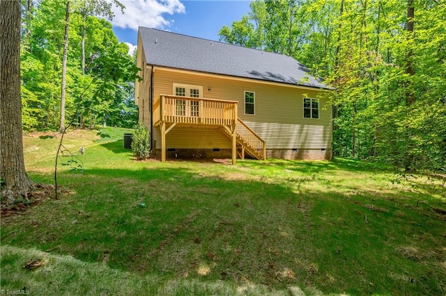 rear view of property with crawl space, stairway, a deck, a yard, and a shingled roof