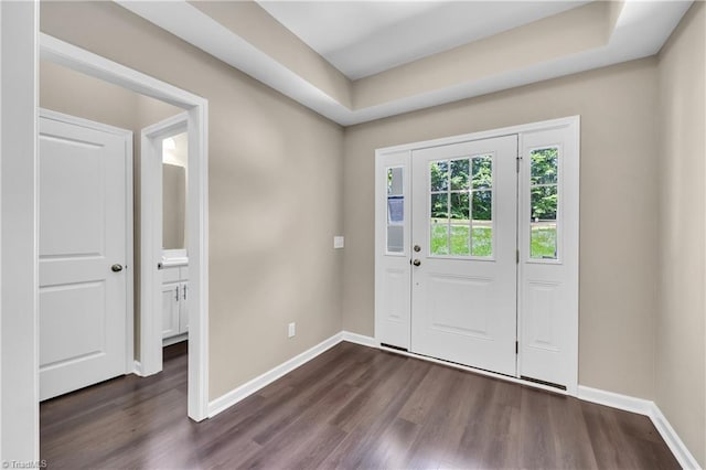 foyer featuring dark wood finished floors and baseboards