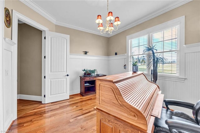 office space featuring ornamental molding, light hardwood / wood-style floors, and a chandelier