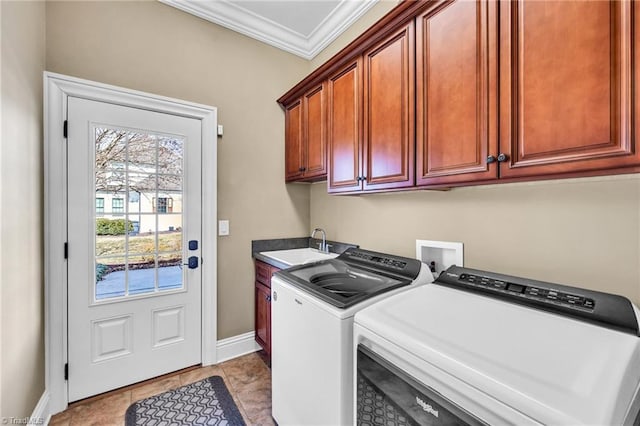 washroom featuring light tile patterned flooring, sink, crown molding, cabinets, and washer and dryer