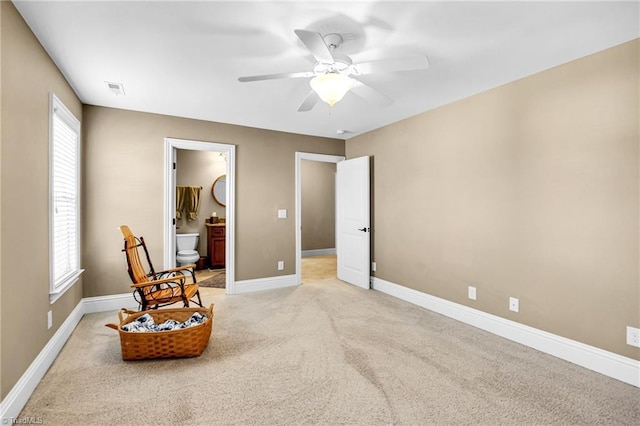 living area with light colored carpet and ceiling fan