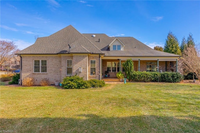 rear view of house with a yard