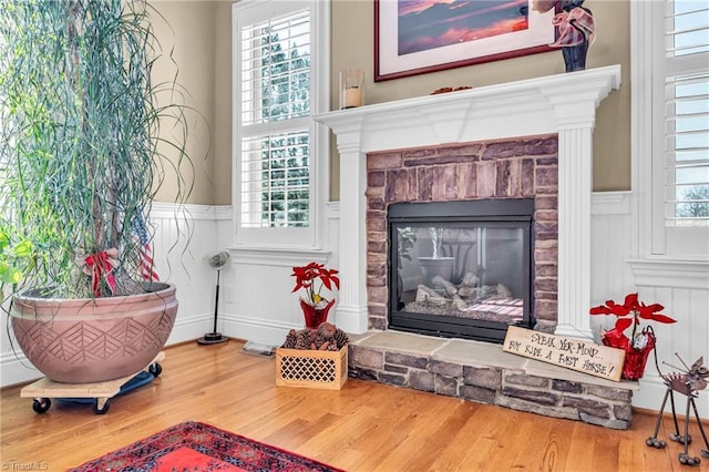 sitting room featuring hardwood / wood-style flooring, a fireplace, and a healthy amount of sunlight