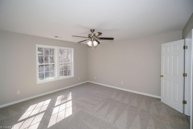 unfurnished room featuring ceiling fan and light carpet