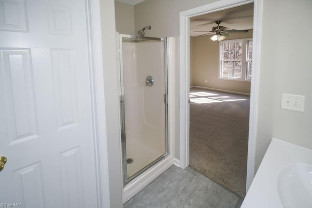 bathroom featuring ceiling fan, vanity, and a shower with door