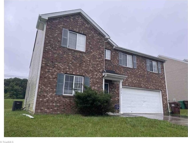 4012 Banbridge Dr, High Point, NC 27260 - view of front of house with a garage, concrete driveway, brick siding, and a front lawn