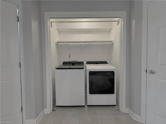 12 Cedar Knoll Ct Unit 12, Greensboro, NC 27407 - washroom with washer and dryer and light tile patterned floors