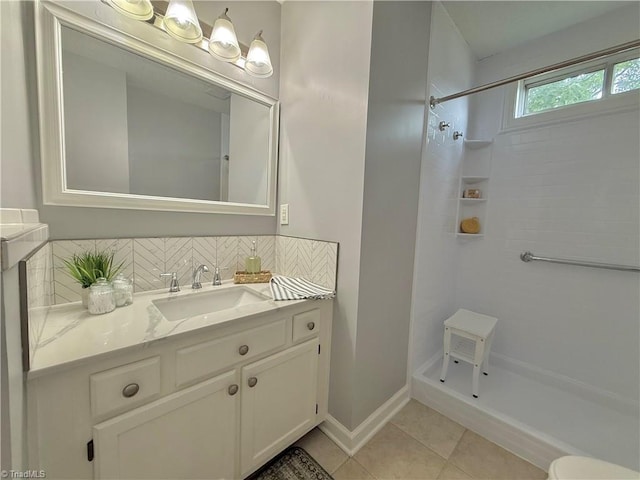 12 Cedar Knoll Ct Unit 12, Greensboro, NC 27407 - bathroom with vanity, tiled shower, tile patterned floors, and decorative backsplash