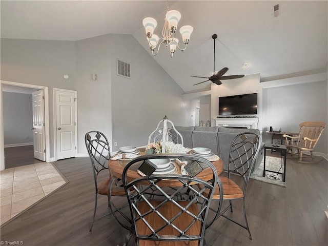 12 Cedar Knoll Ct Unit 12, Greensboro, NC 27407 - dining room featuring a ceiling fan, dark wood-type flooring, a chandelier, and high vaulted ceiling