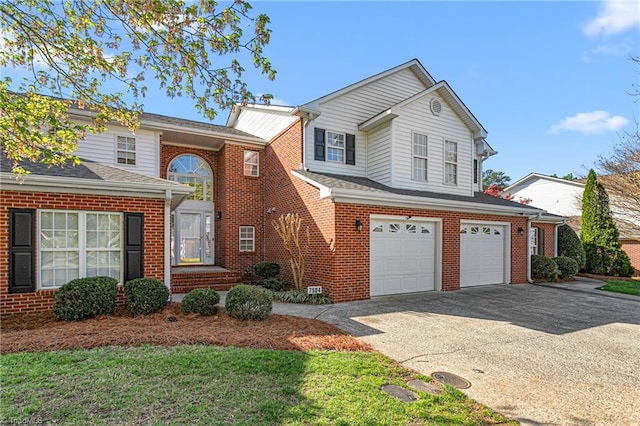 traditional-style house with an attached garage, driveway, and brick siding
