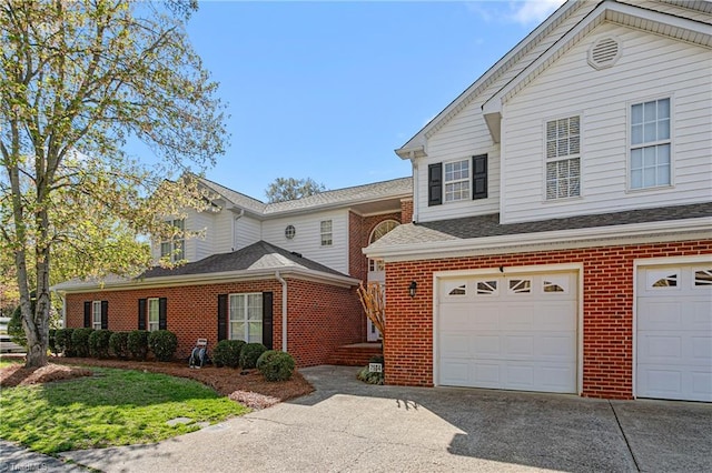 view of front of home featuring brick siding, a garage, and concrete driveway
