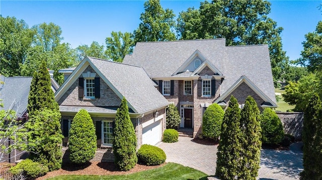 craftsman-style home with an attached garage and driveway