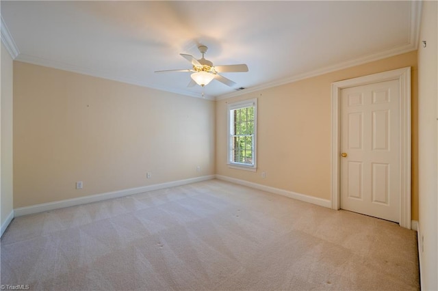 spare room featuring baseboards, ornamental molding, and ceiling fan