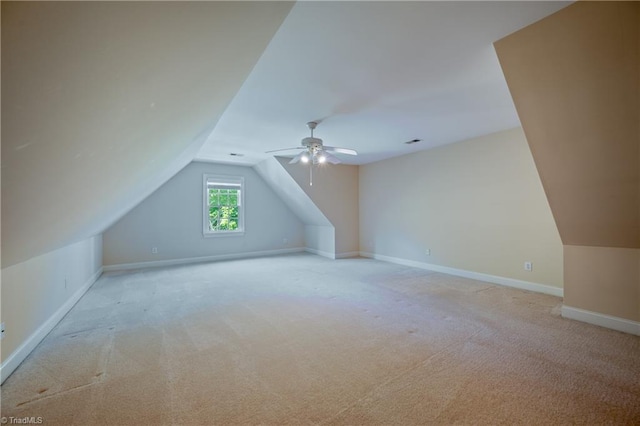 bonus room featuring baseboards, ceiling fan, light colored carpet, and lofted ceiling