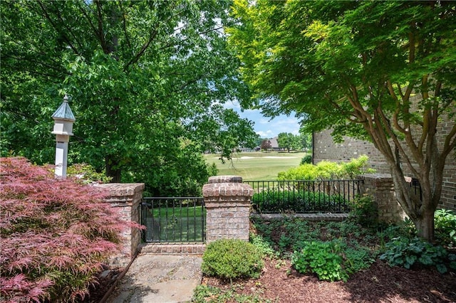surrounding community with a gate and fence