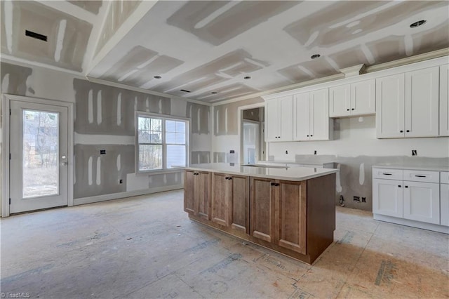 kitchen with a center island with sink and white cabinets