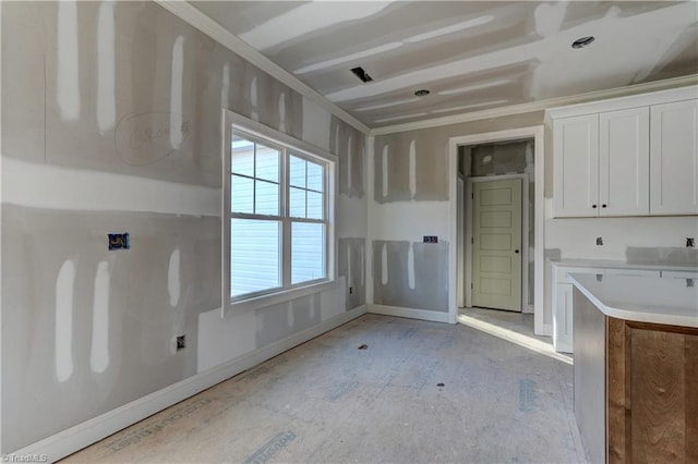 kitchen featuring white cabinetry and crown molding