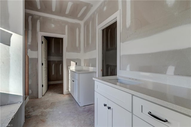 bathroom featuring concrete flooring and vanity