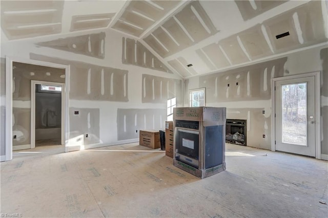 unfurnished living room with a fireplace and vaulted ceiling