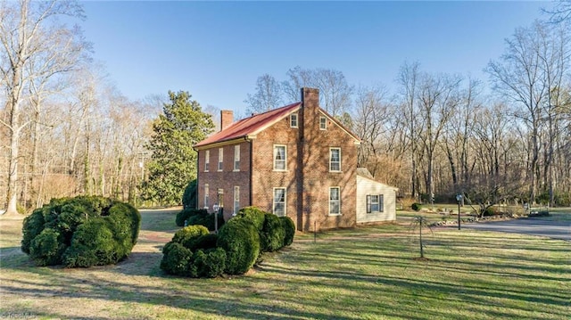 view of side of home featuring a yard