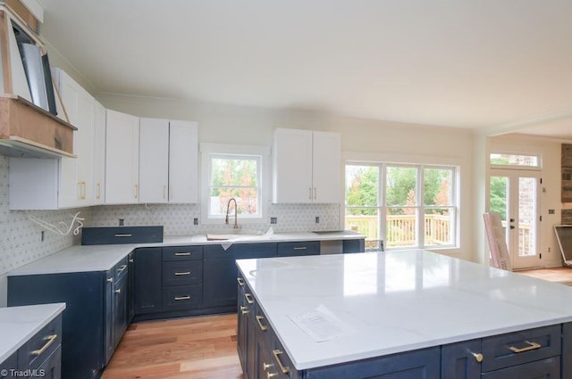 3799 Peony Way, Clemmons, NC 27012 - kitchen with tasteful backsplash, white cabinets, light wood-style flooring, and a sink