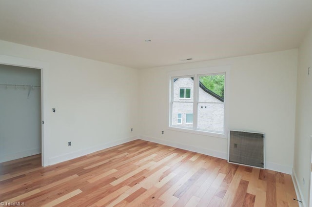 3799 Peony Way, Clemmons, NC 27012 - unfurnished bedroom with light wood-type flooring, a closet, and baseboards