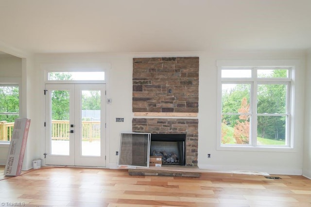 3799 Peony Way, Clemmons, NC 27012 - unfurnished living room featuring visible vents, hardwood / wood-style floors, french doors, and a fireplace