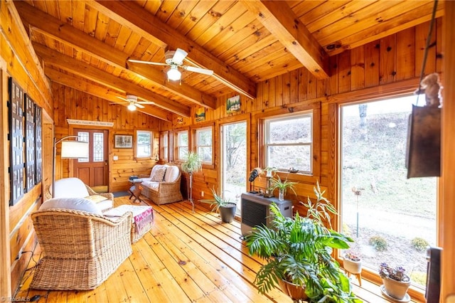 sunroom / solarium with vaulted ceiling with beams, wooden ceiling, and a wealth of natural light