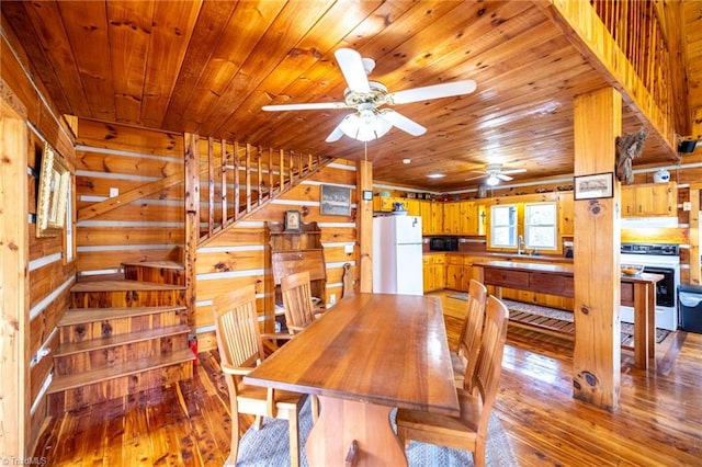 dining space with wooden ceiling, wood walls, and light wood-style floors