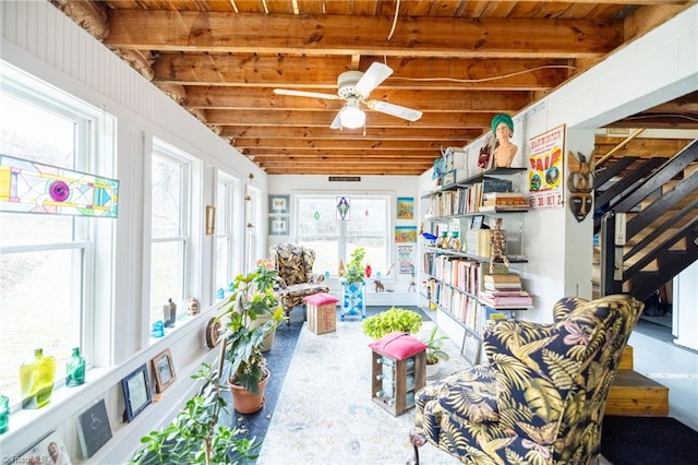 sunroom / solarium featuring a ceiling fan