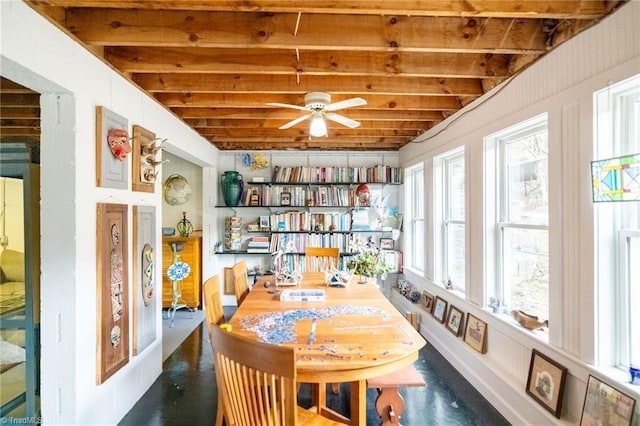 interior space featuring a ceiling fan and beamed ceiling