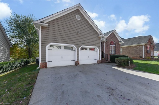 view of front of property with a garage, concrete driveway, and a front lawn