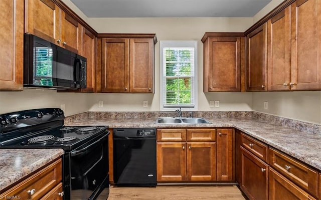 810 Mobile St, High Point, NC 27262 - kitchen featuring black appliances, a sink, and light wood-type flooring