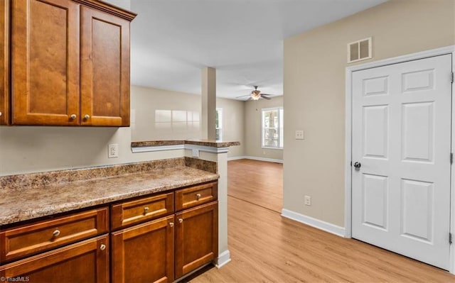 810 Mobile St, High Point, NC 27262 - kitchen featuring ceiling fan, light wood-type flooring, baseboards, and brown cabinets
