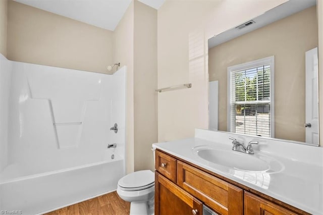 810 Mobile St, High Point, NC 27262 - full bath featuring toilet, wood finished floors, vanity, and shower / tub combination
