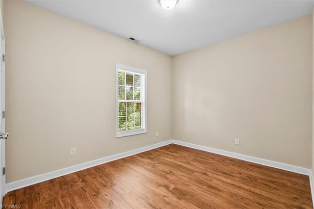 810 Mobile St, High Point, NC 27262 - unfurnished room with baseboards and wood finished floors