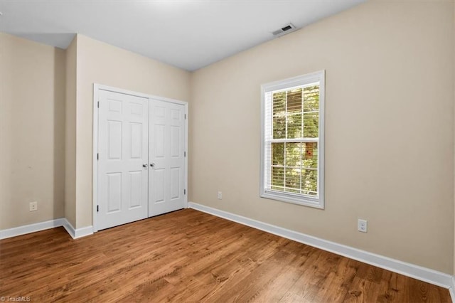 810 Mobile St, High Point, NC 27262 - unfurnished bedroom featuring light wood-style flooring, baseboards, and a closet