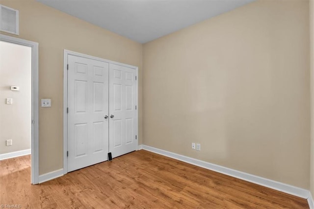 810 Mobile St, High Point, NC 27262 - unfurnished bedroom with baseboards and light wood finished floors