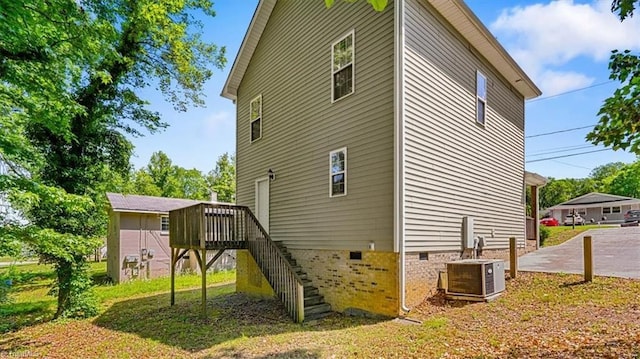 810 Mobile St, High Point, NC 27262 - view of side of home featuring crawl space, central air condition unit, stairs, and a wooden deck