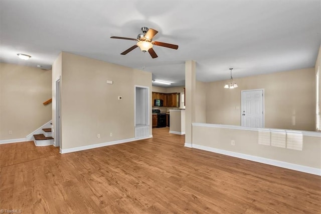 810 Mobile St, High Point, NC 27262 - unfurnished living room featuring ceiling fan, light wood-style flooring, a chandelier, and baseboards