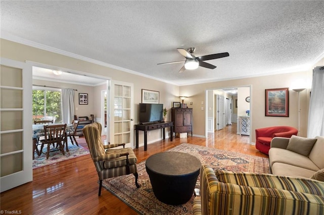 4012 Clarendon Ave, Winston-Salem, NC 27106 - living area with ornamental molding, a textured ceiling, a ceiling fan, and wood finished floors