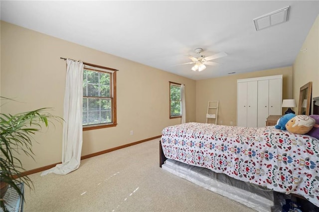 4012 Clarendon Ave, Winston-Salem, NC 27106 - carpeted bedroom with multiple windows, a closet, and ceiling fan