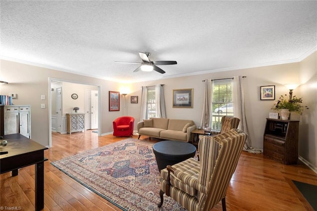 4012 Clarendon Ave, Winston-Salem, NC 27106 - living room with ornamental molding, a ceiling fan, a textured ceiling, and light wood finished floors