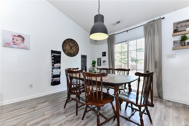 dining area featuring visible vents, baseboards, and wood finished floors