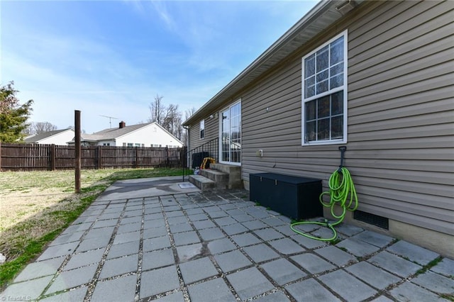 view of patio featuring entry steps and fence