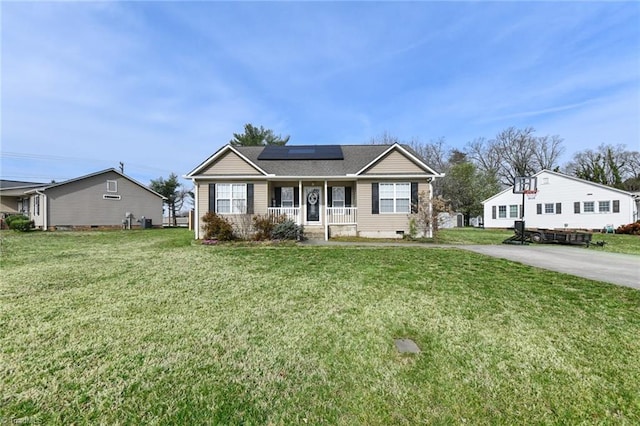 view of front of property with crawl space, roof mounted solar panels, covered porch, and a front yard