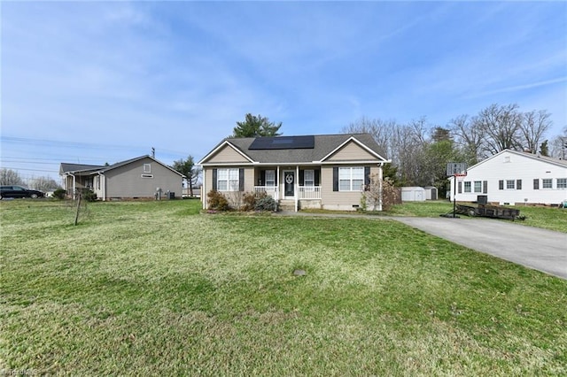 view of front of house featuring crawl space, covered porch, solar panels, and a front yard