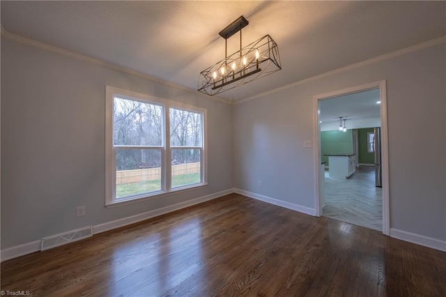 unfurnished dining area featuring dark hardwood / wood-style flooring, ornamental molding, and a chandelier